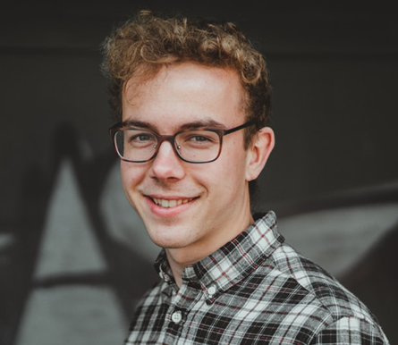 Photo of male student with glasses.